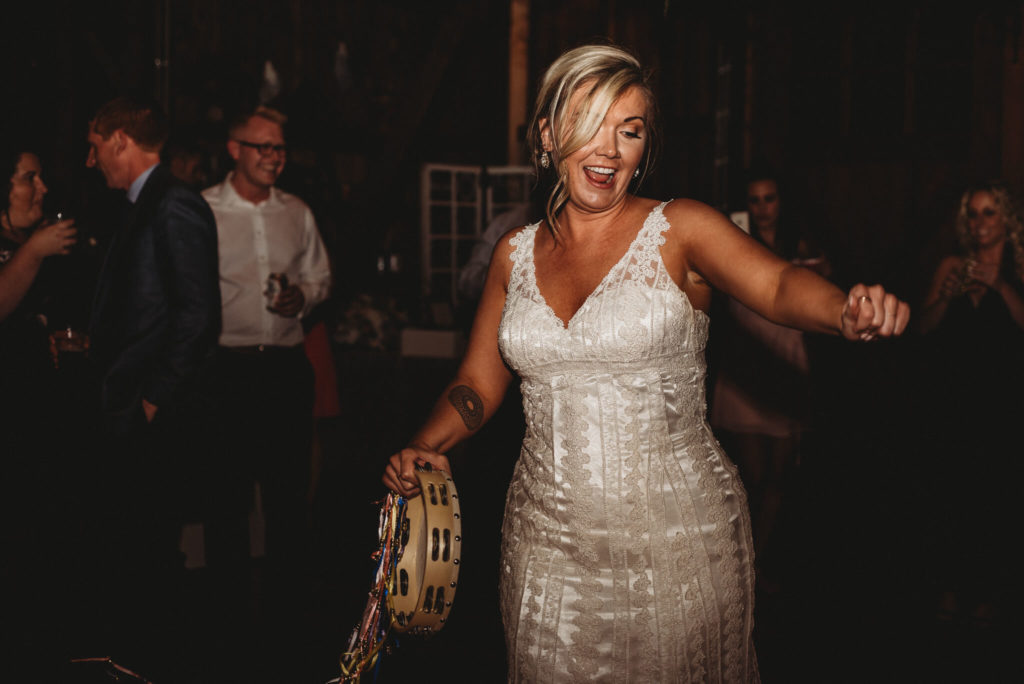 bride dancing with tambourine at century farms