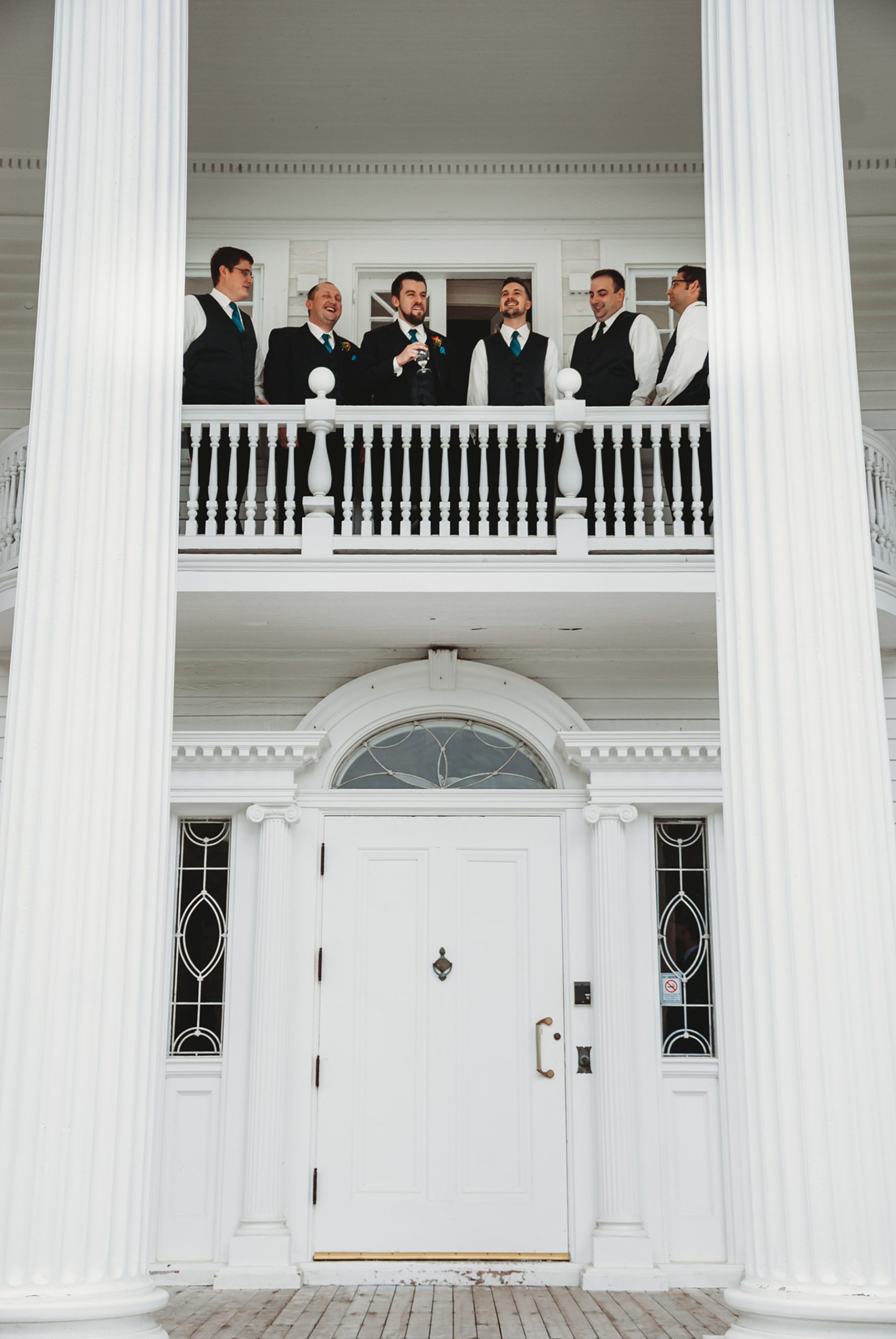 Groomsmen on balcony of Mooreland Mansion wedding in Kirtland OH