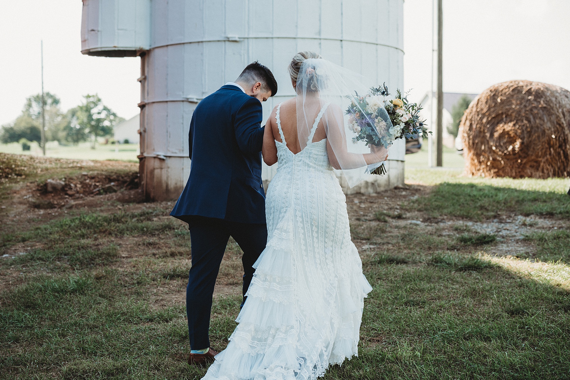 newlyweds walk outside silos at century farms in ohio 