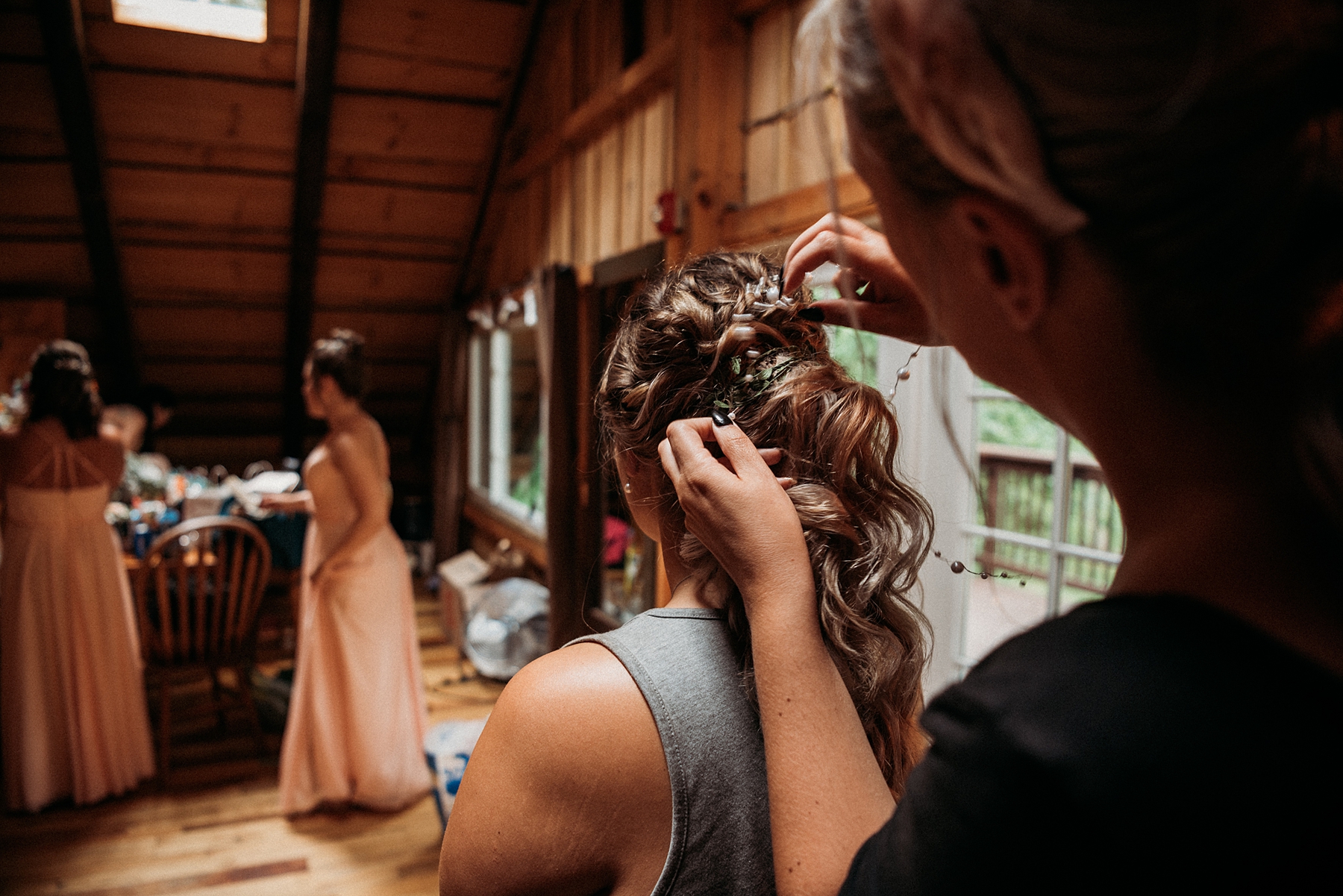 bride getting hair done before wedding