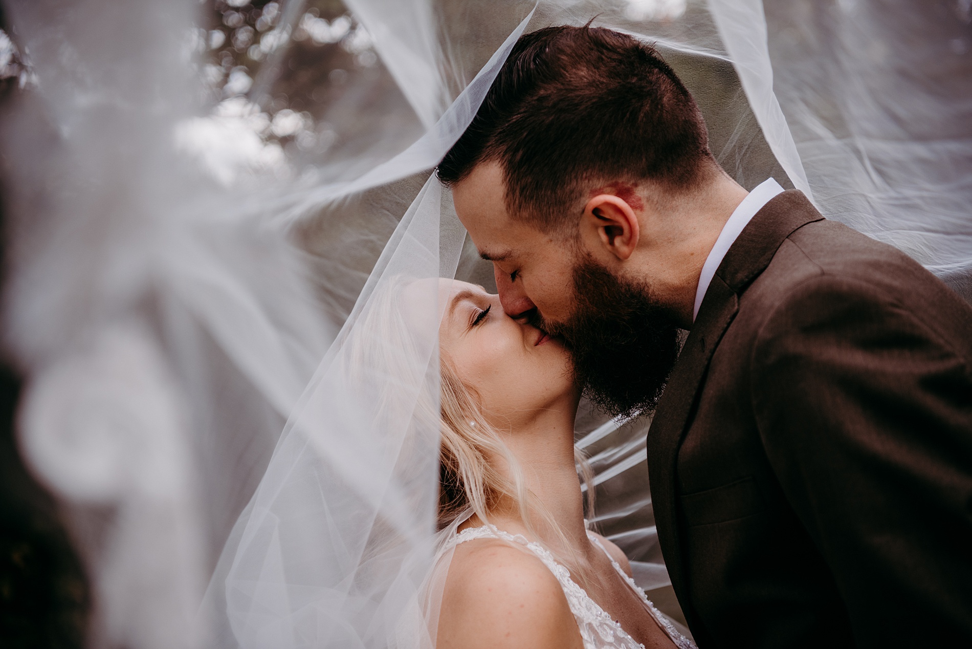 bride and groom wedding portraits surrounded by floating veil 