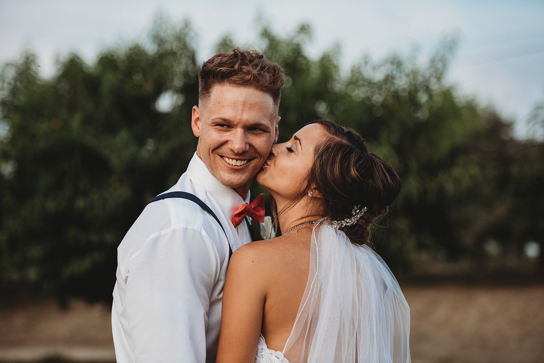 bride kisses groom at Varian Orchards wedding 