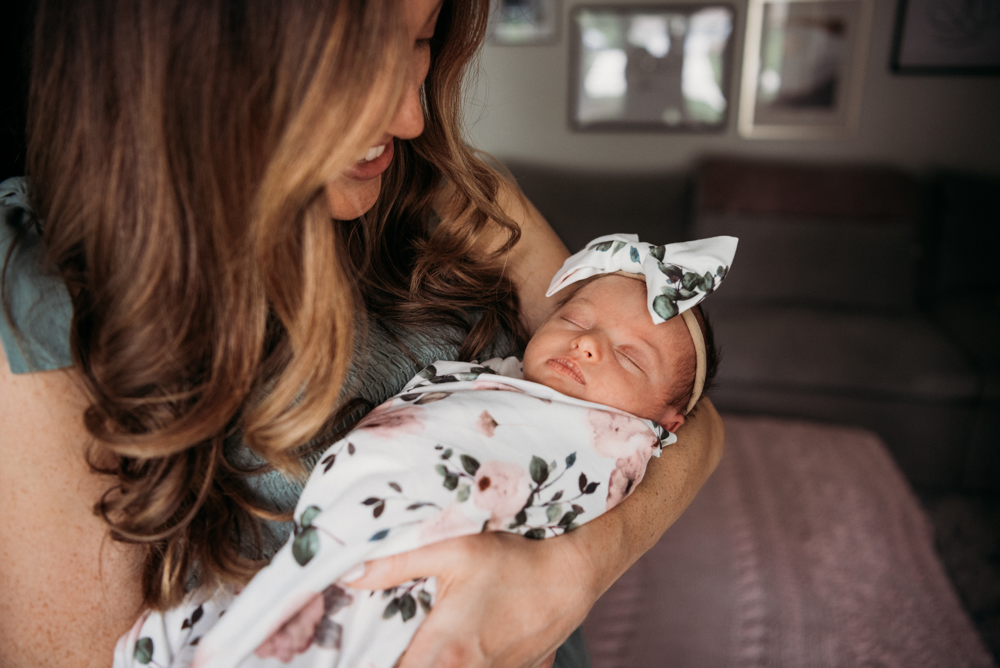 new mom holding her newborn girl in her nursery Cleveland Pediatricians