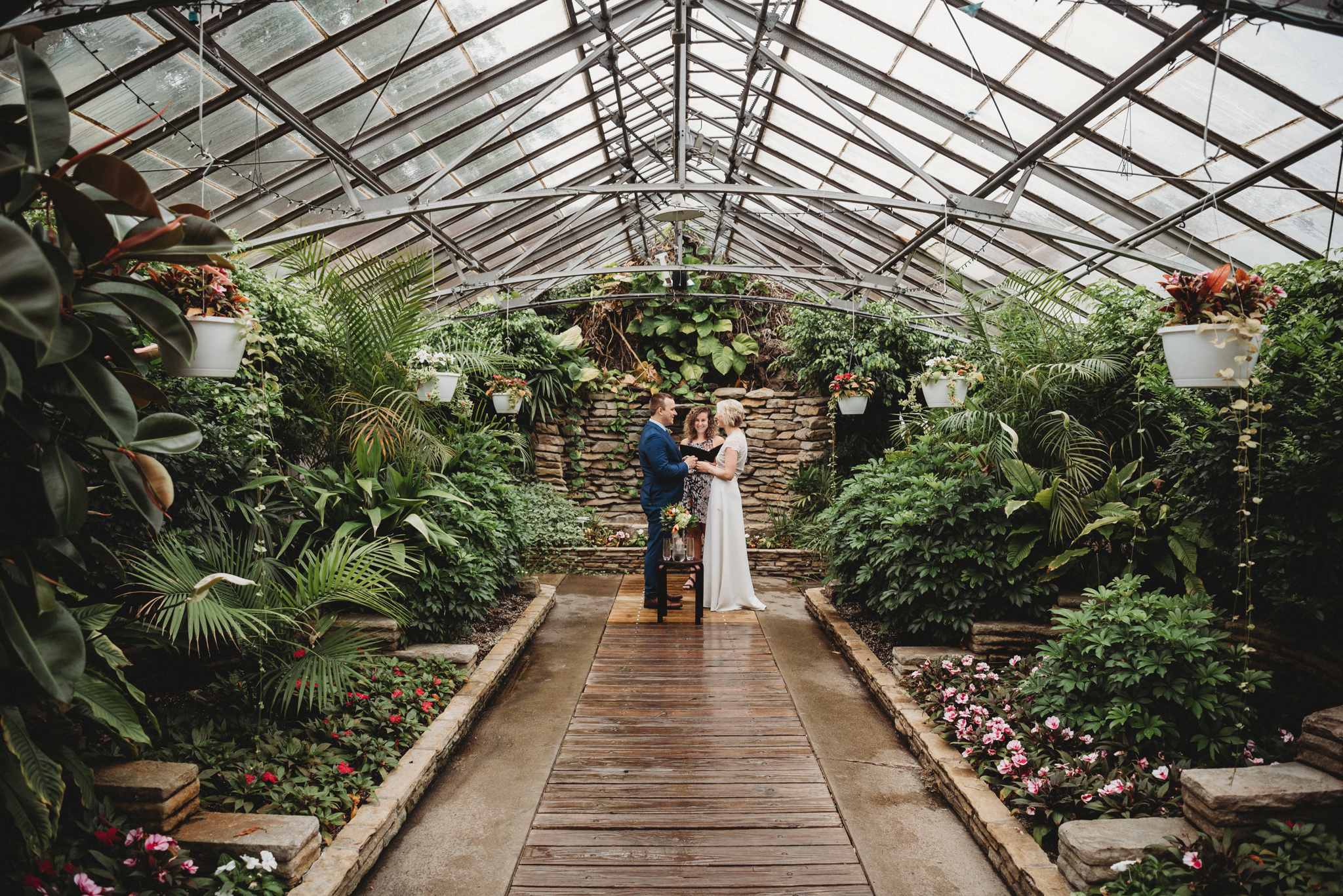 bride and groom exchanging vows in a greenhouse Elope Ohio