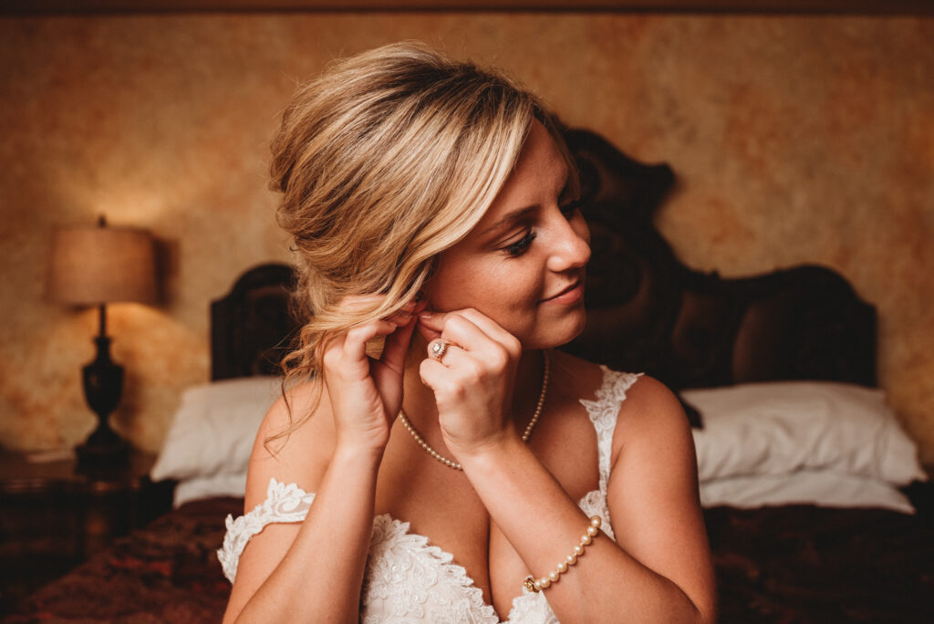 bride putting on her earrings at Landoll's Mohican Castle wedding